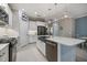 Elegant kitchen with white cabinetry, stainless steel appliances, large island and pendant lighting at 12706 Cobalt Ter, Bradenton, FL 34211