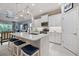 Bright white kitchen features a center island with seating, modern appliances, and stylish pendant lighting at 12706 Cobalt Ter, Bradenton, FL 34211