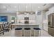 Modern kitchen featuring white cabinetry, stainless steel appliances, a center island with seating, and pendant lighting at 12706 Cobalt Ter, Bradenton, FL 34211