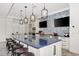 Modern kitchen with a large island, sleek countertops, stainless steel appliances, and stylish mosaic tile backsplash at 12706 Cobalt Ter, Bradenton, FL 34211
