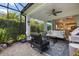 Inviting screened lanai with ceiling fan, stylish furniture, lush greenery, and seamless indoor-outdoor transition at 12706 Cobalt Ter, Bradenton, FL 34211