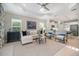 Open-concept living room with coffered ceiling, large windows, and seamless flow to the kitchen at 12706 Cobalt Ter, Bradenton, FL 34211