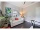 Bright office featuring a sofa, accent pillows, plantation shutters and green wall art at 12706 Cobalt Ter, Bradenton, FL 34211
