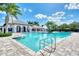 Community pool featuring a spacious deck, covered seating, and lush landscaping, perfect for leisure and relaxation at 12706 Cobalt Ter, Bradenton, FL 34211