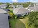 Aerial view of a well-maintained home with a screened-in lanai and lush backyard landscaping at 12706 Cobalt Ter, Bradenton, FL 34211
