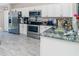 Modern kitchen featuring stainless steel appliances, granite countertops, and ample cabinet space at 13257 Sw 29Th Cir, Ocala, FL 34473