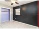 Bedroom with dark walls, tiled floor and closet at 1401 Francis Ave, Sarasota, FL 34232