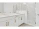 Modern bathroom showcasing double sink vanity with gold hardware and a glass shower at 15001 Shady Palms Ln, Nokomis, FL 34275