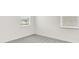 Clean bedroom with neutral carpet and two windows providing natural light at 15001 Shady Palms Ln, Nokomis, FL 34275