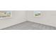 Bare bedroom with neutral carpet and two windows providing natural light at 15001 Shady Palms Ln, Nokomis, FL 34275