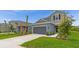 Exterior of a two-story home featuring well-maintained landscaping and a gray two-car garage at 15001 Shady Palms Ln, Nokomis, FL 34275