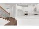 Bright, modern kitchen with white cabinets, gold hardware, stainless steel appliances, and spacious island with sink at 15001 Shady Palms Ln, Nokomis, FL 34275