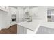 Bright and airy kitchen with white cabinets, stainless steel appliances, and a large island with a modern faucet at 15001 Shady Palms Ln, Nokomis, FL 34275