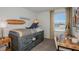 Charming bedroom with unique decor, including a surfboard wall hanging and beach-themed accents at 15048 Cuzcorro Ct, Nokomis, FL 34275