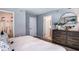 Serene bedroom with a large bed, dresser, and ample closet space at 15048 Cuzcorro Ct, Nokomis, FL 34275