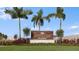 Entrance to the Vinterra Townhomes with palm trees and landscaping at 15048 Cuzcorro Ct, Nokomis, FL 34275