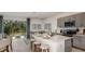 Modern kitchen with white counters, seating, gray cabinets, and stainless steel appliances at 15048 Cuzcorro Ct, Nokomis, FL 34275