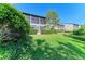 Serene backyard view showcasing lush green grass, landscaping, and private patio at 1617 Bayhouse Ct # 121, Sarasota, FL 34231