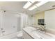 Well-lit bathroom with a bathtub and shower combination and a marble countertop vanity at 1617 Bayhouse Ct # 121, Sarasota, FL 34231