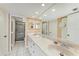 Well-lit bathroom featuring double sinks, neutral color scheme, and a walk-in shower at 1617 Bayhouse Ct # 121, Sarasota, FL 34231