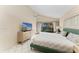Comfortable bedroom with a vaulted ceiling, slider to the outside, dresser with a TV, and bright, sunny exposure at 1617 Bayhouse Ct # 121, Sarasota, FL 34231