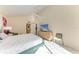 Bright bedroom with vaulted ceiling, slider to the outside, dresser with TV, and access to a bathroom at 1617 Bayhouse Ct # 121, Sarasota, FL 34231