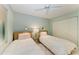 Comfortable bedroom showcasing twin beds, ceiling fan, closet, and relaxing interior at 1617 Bayhouse Ct # 121, Sarasota, FL 34231