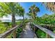 Charming wooden boardwalk surrounded by lush greenery and leading to the waterfront at 1617 Bayhouse Ct # 121, Sarasota, FL 34231