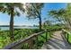 Scenic boardwalk path winding through tropical foliage with stunning waterfront views at 1617 Bayhouse Ct # 121, Sarasota, FL 34231
