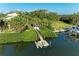 Picturesque dock with boat lift surrounded by lush tropical greenery, providing easy access to waterfront activities at 1617 Bayhouse Ct # 121, Sarasota, FL 34231