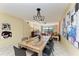 Open dining and living space with modern light fixture and art on walls at 1617 Bayhouse Ct # 121, Sarasota, FL 34231