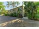 Exterior shot of condo building showcasing the entrance and lush landscaping at 1617 Bayhouse Ct # 121, Sarasota, FL 34231