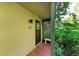 Inviting front porch with decorative lattice, bench, and well-manicured plants at 1617 Bayhouse Ct # 121, Sarasota, FL 34231