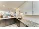 Modern kitchen with granite countertops, white cabinets, and stainless steel appliances at 1617 Bayhouse Ct # 121, Sarasota, FL 34231