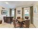 Cozy living room featuring classic molding, neutral paint and furnishings, and multiple windows at 1617 Bayhouse Ct # 121, Sarasota, FL 34231
