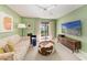 Stylish living room with colorful furnishings, sliding glass doors, and a large TV at 1617 Bayhouse Ct # 121, Sarasota, FL 34231