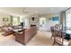Spacious living room with ample seating, a decorative fireplace, and natural light pouring through the windows at 1617 Bayhouse Ct # 121, Sarasota, FL 34231