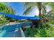 Lush landscaped outdoor area with seating and shade, perfect for relaxing and enjoying nature at 1617 Bayhouse Ct # 121, Sarasota, FL 34231