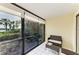 Relaxing sunroom area with tiled floor and beautiful views of landscaped greenery and waterfront at 1617 Bayhouse Ct # 121, Sarasota, FL 34231