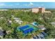 Aerial view of community tennis courts, surrounded by lush greenery, offering a scenic recreational amenity at 1617 Bayhouse Ct # 121, Sarasota, FL 34231