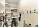 Well-organized walk-in closet featuring shelves, hooks, and storage for various items at 1617 Bayhouse Ct # 121, Sarasota, FL 34231