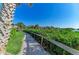 Picturesque walkway lined with lush greenery, offering a peaceful path to enjoy the natural surroundings at 1617 Bayhouse Ct # 121, Sarasota, FL 34231