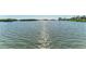 Scenic waterfront view showcasing the glistening water and lush green shoreline at 1617 Bayhouse Ct # 121, Sarasota, FL 34231