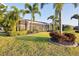 A well-manicured backyard featuring a screened-in patio and tropical landscaping for relaxation and outdoor enjoyment at 16309 Castle Park Ter, Lakewood Ranch, FL 34202