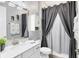 Well-lit bathroom showcasing granite countertop, framed mirror, and shower with curtain at 16309 Castle Park Ter, Lakewood Ranch, FL 34202