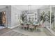 Bright dining room with decorative light fixture, plants, large mirror, and elegant window treatments at 16309 Castle Park Ter, Lakewood Ranch, FL 34202