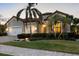 Charming home featuring a tile roof, a well-manicured lawn, and lush landscaping at 16309 Castle Park Ter, Lakewood Ranch, FL 34202