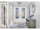 Bright foyer with decorative glass double doors and elegant decor at 16309 Castle Park Ter, Lakewood Ranch, FL 34202