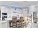 Bright kitchen features stainless appliances, white cabinets, an island and stylish pendant lights at 16309 Castle Park Ter, Lakewood Ranch, FL 34202
