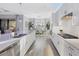 Open concept kitchen with stainless appliances, quartz countertops, large island, and adjoining dining room at 16309 Castle Park Ter, Lakewood Ranch, FL 34202